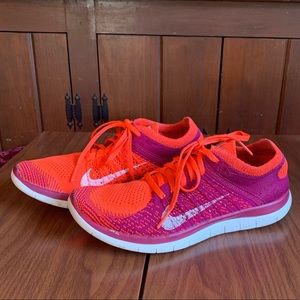 Coral and Pink Nike Flynit Sneakers